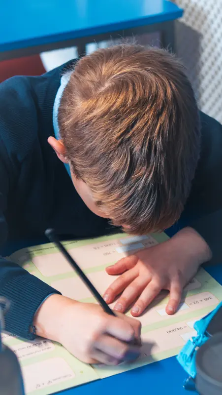 Pupil concentrating on his work in the classroom