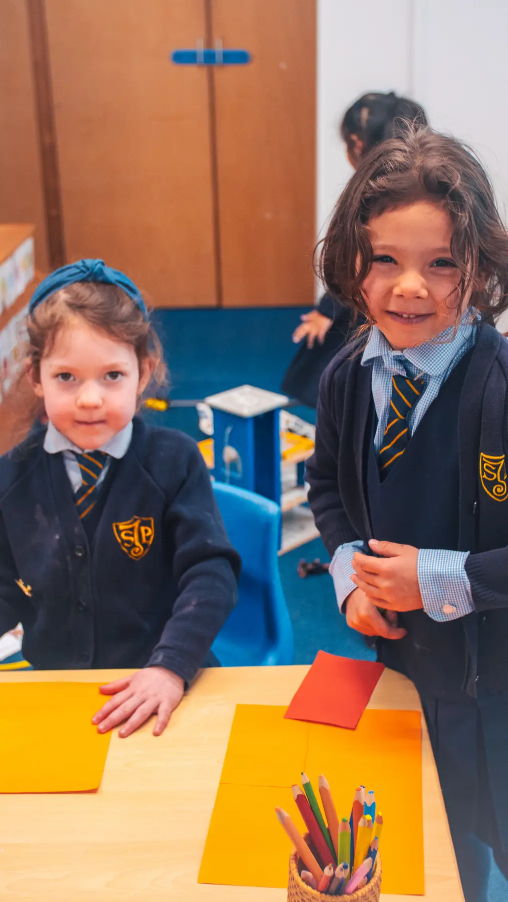 Young pupils enjoying a craft activity in Early Years