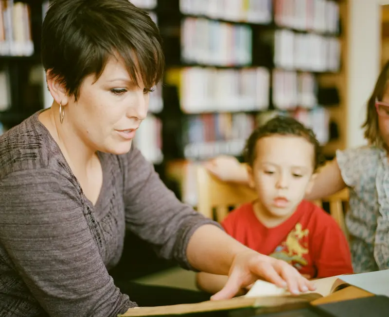 A teacher reading one-to-one with a young pupil