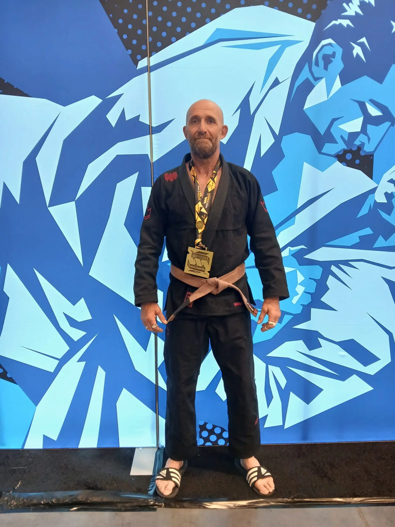 A St John's Priory teacher wearing his gold medal after winning a Brazilian Jiu-Jitsu championship